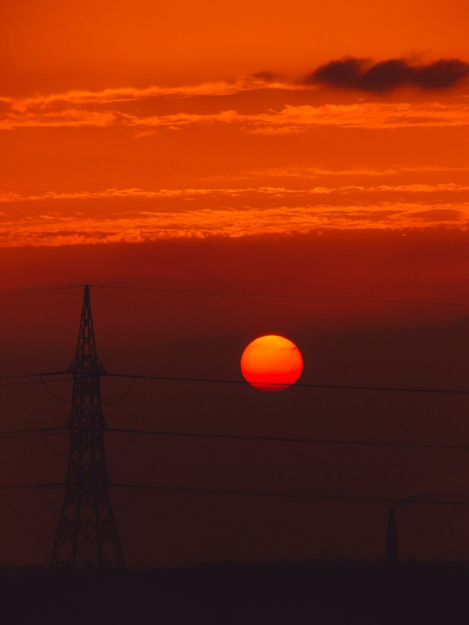 a sunset over a power line